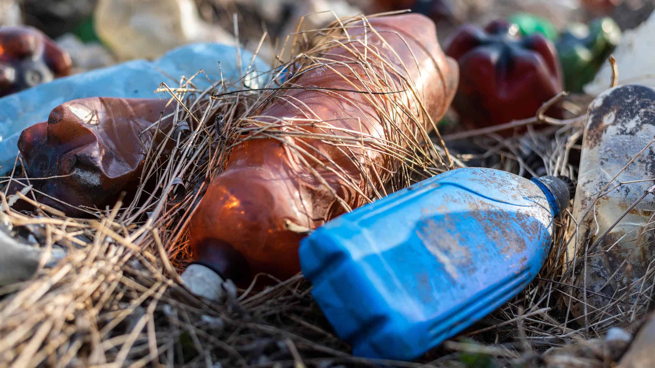 Closeup of Ground with a lot of scattered plastic bottles