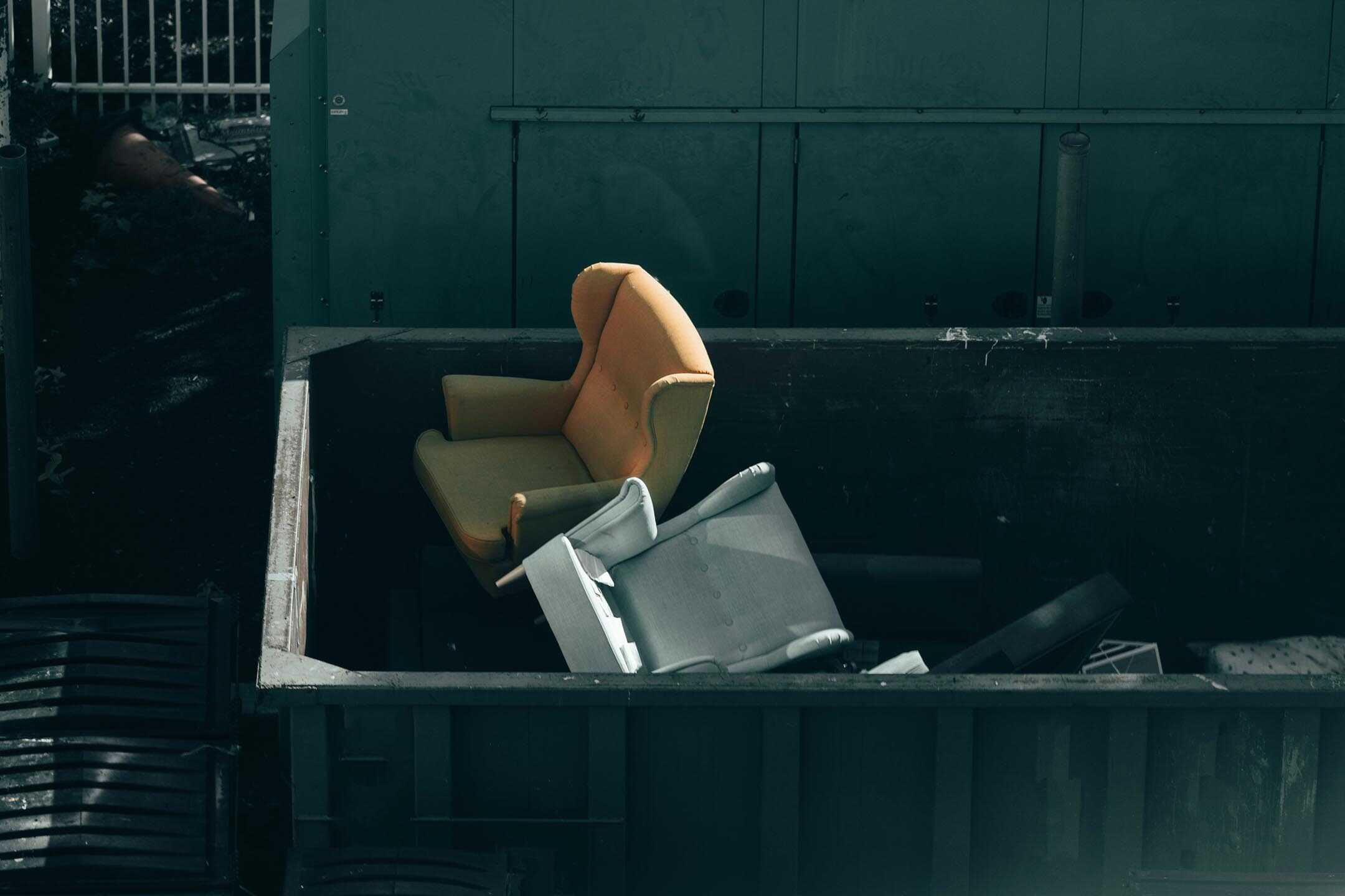 Dumped chairs in a skip